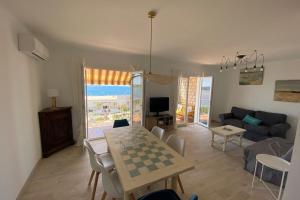 a living room with a chess table and a couch at T3 refait à neuf vue mer en centre ville parking in Bandol
