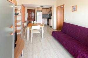 a living room with a purple couch and a table at Infante in Puerto de Gandía +9 photos