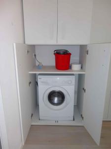 a washing machine with a bucket on top of it at Apartment in Porto Santa Margherita 27854 in Porto Santa Margherita di Caorle