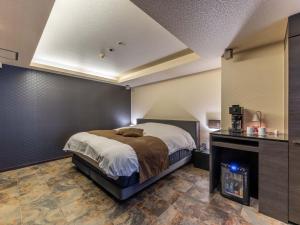 Postel nebo postele na pokoji v ubytování HOTEL felice Osaka -伊丹空港-