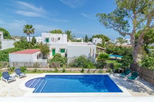 a villa with a swimming pool and a house at Villa Cala Esmeralda in Cala d´Or