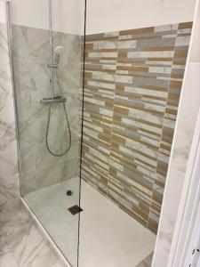 a shower with a glass door in a bathroom at Saint Florent T2 Plein Centre in Saint-Florent