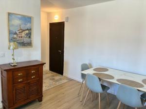 a dining room with a table and blue chairs at Saint Florent T2 Plein Centre in Saint-Florent