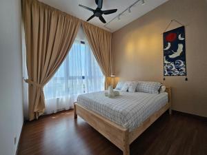 a bedroom with a bed with a ceiling fan and a window at Setia Alam Convention Centre 3 Bedroom 2-9Pax #33 in Shah Alam +66 photos