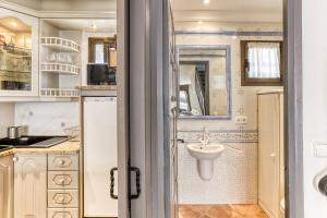 a small bathroom with a sink and a toilet at Port Empúries in Empuriabrava +26 photos