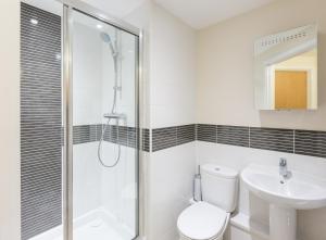 a bathroom with a shower and a toilet and a sink at House of Fisher - Central Gate in Newbury