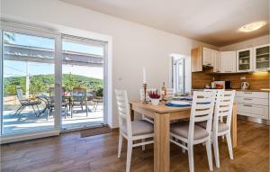 a kitchen and dining room with a table and chairs at Lovely Home In Brbinj With Wifi in Brbinj