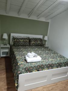 a bedroom with a bed with two towels on it at Terrazza sul corso in Aragona