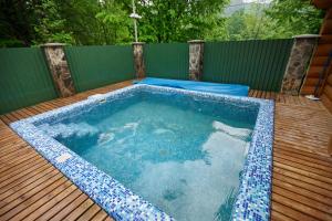 a pool with a pool table and a pool tub at Chudodievo in Chynadievo Mini-Hotel in Chynadiyovo