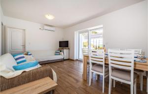 a living room with a table and chairs and a couch at Lovely Home In Brbinj With Wifi in Brbinj