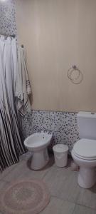 a bathroom with a toilet and a bidet at Casa Quinta San Miguel del Monte in San Miguel del Monte