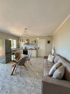 a living room with a couch and a table and a kitchen at Casa Limone in Argostoli