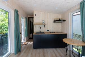 a small kitchen with a counter and a table at Baltic Beach Houses & First Line in Jūrmala
