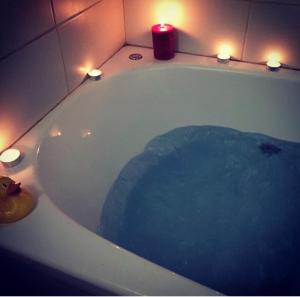 a bath tub with a candle and lights in it at Lasmari's Bouquet in Sykopetra +41 photos