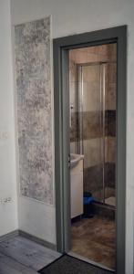 a door to a bathroom with a shower and a tub at Casa Alba in Mamaia Nord