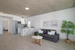 a living room and kitchen with a couch and a table at Playa de Guacimeta - Maresia in Playa Honda +20 photos