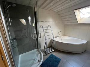 a bathroom with a large tub and a shower at chambre d'hôte Francorchamps in Francorchamps