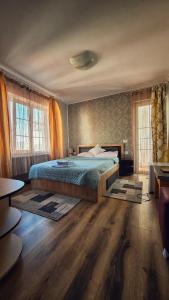 a bedroom with a bed and two windows at Casa Alba in Mamaia Nord
