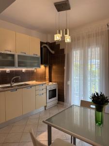 a kitchen with a table and a sink and a stove at Endless summer,Agia Triada in Agia Triada