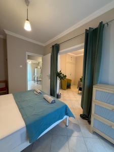 a bedroom with a large bed with a blue blanket at Endless summer,Agia Triada in Agia Triada +14 photos