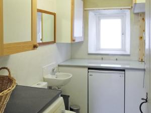 a small bathroom with a sink and a toilet at Lilac Cottage in Hawes +7 photos