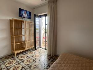 a room with a bed and a sliding glass door at Titanya - Bed And Breakfast Di Galatea Casa Vacanze in Corsano