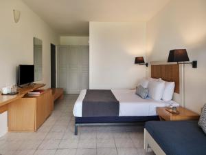 A bed or beds in a room at Aeolos Beach Resort