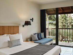A bed or beds in a room at Aeolos Beach Resort