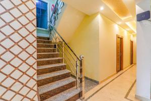 a staircase in a house with yellow walls at FabHotel Super 3 Premium in Varanasi +21 photos