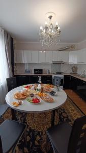 a table with food on it in a kitchen at Mery in Karakol +19 photos