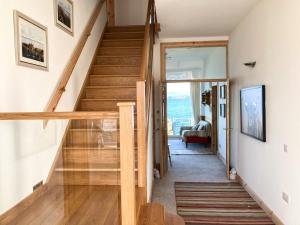 a staircase in a house with wooden floors at The Old School House in Lonbain