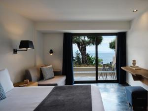 A bed or beds in a room at Aeolos Beach Resort