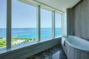 a bathroom with a tub and large windows at Hyatt Regency Istanbul Atakoy in Istanbul