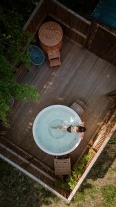 a woman in a bath tub on a wooden deck at Zen Sasino in Sasino