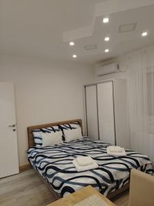 a bedroom with a bed with two pillows on it at Ljilja Studio Apartman in Banja Koviljača