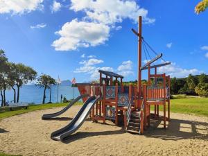 a playground in a park with a slide at TI COCOTIER Studio PREMIUM Village Vacances in Sainte-Luce