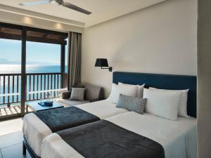 A bed or beds in a room at Aeolos Beach Resort