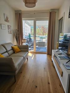 a living room with a couch and a television at Apartment Blicksüd in Unterburg am Klopeiner See