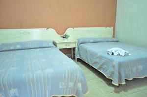 Letto o letti in una camera di Hotel Metropolitan I