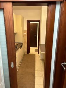 a hallway leading to a kitchen with a door at Apartment Natasa in Budva +13 photos