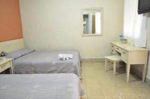 Letto o letti in una camera di Hotel Metropolitan I