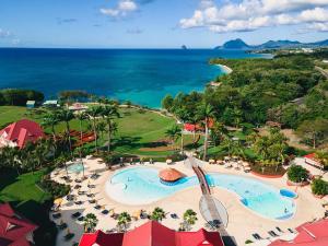 an aerial view of a resort with a pool and the ocean at TI COCOTIER Studio PREMIUM Village Vacances in Sainte-Luce