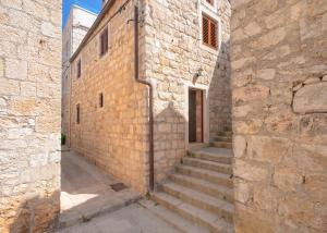 a stone building with stairs leading up to a door at Villa Marea - Old Town Retreat in Hvar
