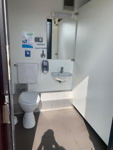 a small bathroom with a toilet and a sink at Voilier Rush Régate Capobar in Boulogne-sur-Mer
