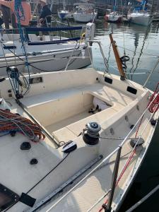 a white boat is docked in the water at Voilier Rush Régate Capobar in Boulogne-sur-Mer