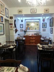 a restaurant with tables and chairs and a counter at Ardlogie Guest House in Aviemore