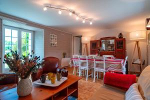 a living room with a table and chairs at Ker West in Carnac