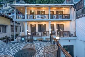 a balcony of a building with tables and chairs at Excel Hotels & Resorts Mall Road Nainital in Nainital