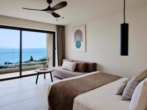 A bed or beds in a room at Aeolos Beach Resort