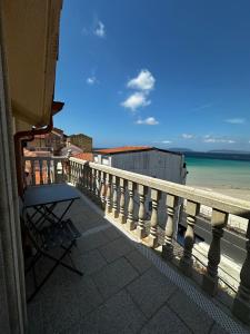 a balcony with a view of the beach and the ocean at Casa da Moa in O Pindo +9 photos